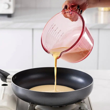 Close-up of the pink glass measuring cups showing clear markings for accurate ingredient measurements.