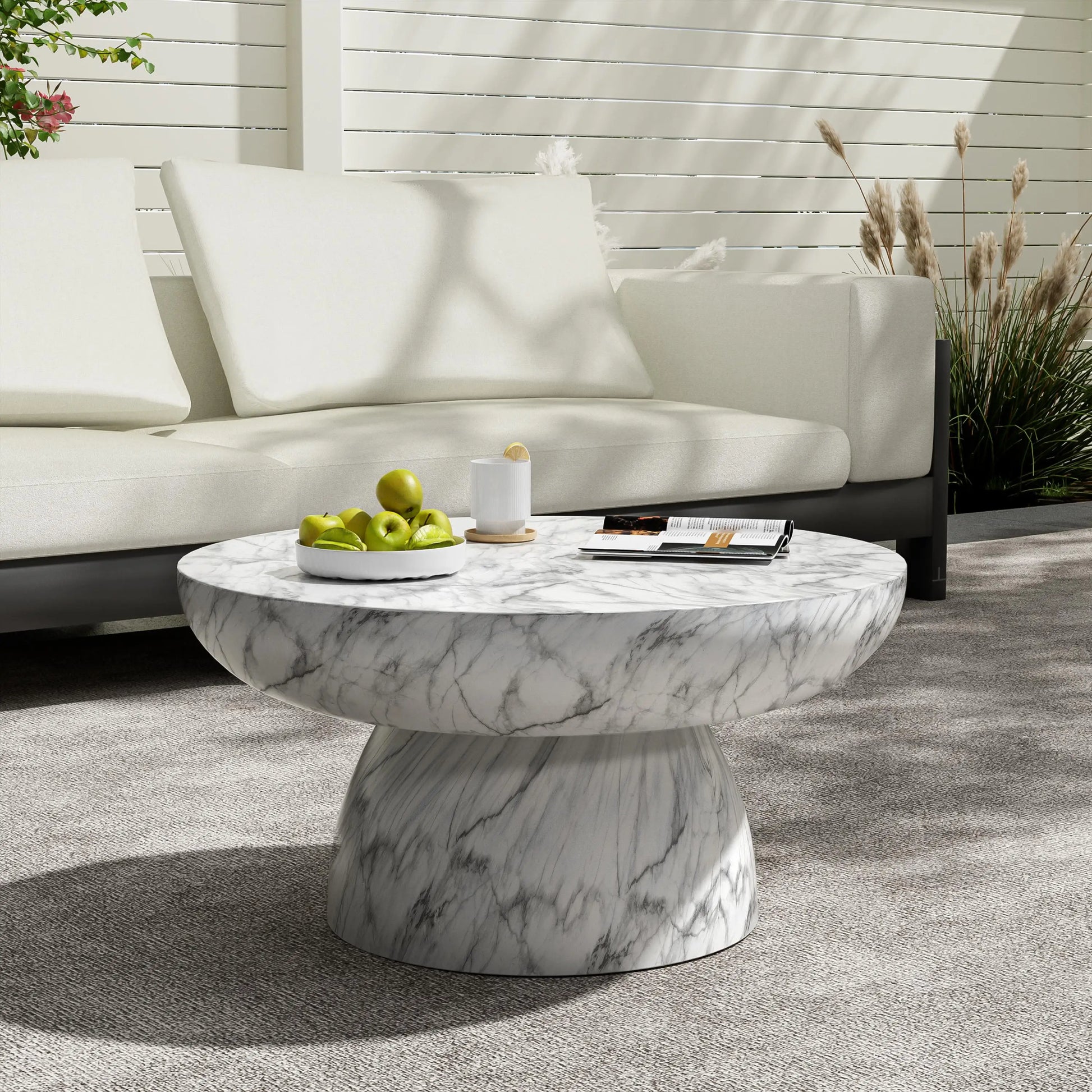 Close-up of the grey veining on the Patsy Luxe Faux Marble Pedestal Coffee Table, emphasizing the quality of this faux marble table in a contemporary setting.