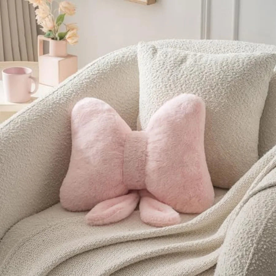 Cozy pink bow throw pillow featuring faux rabbit fur, perfect for adding charm to bedroom and sofa decor.