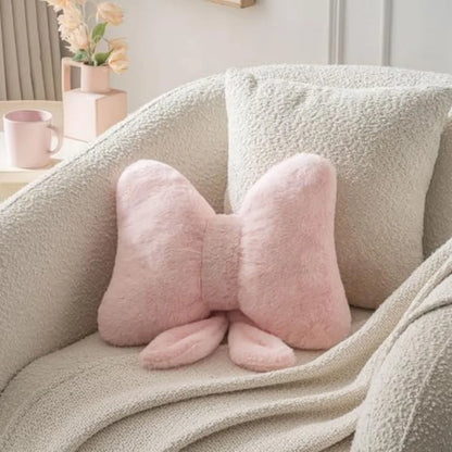 Cozy pink bow throw pillow featuring faux rabbit fur, perfect for adding charm to bedroom and sofa decor.
