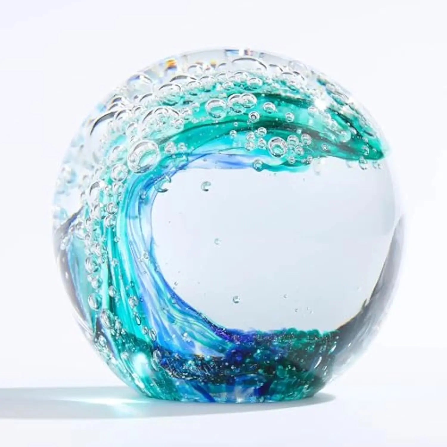 Stylish setting featuring the Hand-Blown Ocean Wave Glass Paperweight, a unique piece that adds coastal charm to any decor.