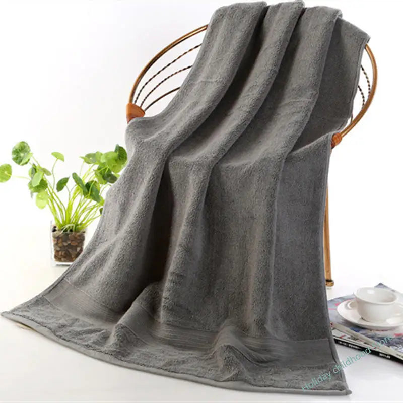 Elegant bathroom setting featuring the Ultra-Soft High-Absorbency Terry Bath Towel draped on a towel bar, epitomizing lightweight luxury and high absorbency.