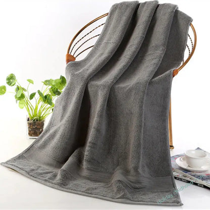 Elegant bathroom setting featuring the Ultra-Soft High-Absorbency Terry Bath Towel draped on a towel bar, epitomizing lightweight luxury and high absorbency.