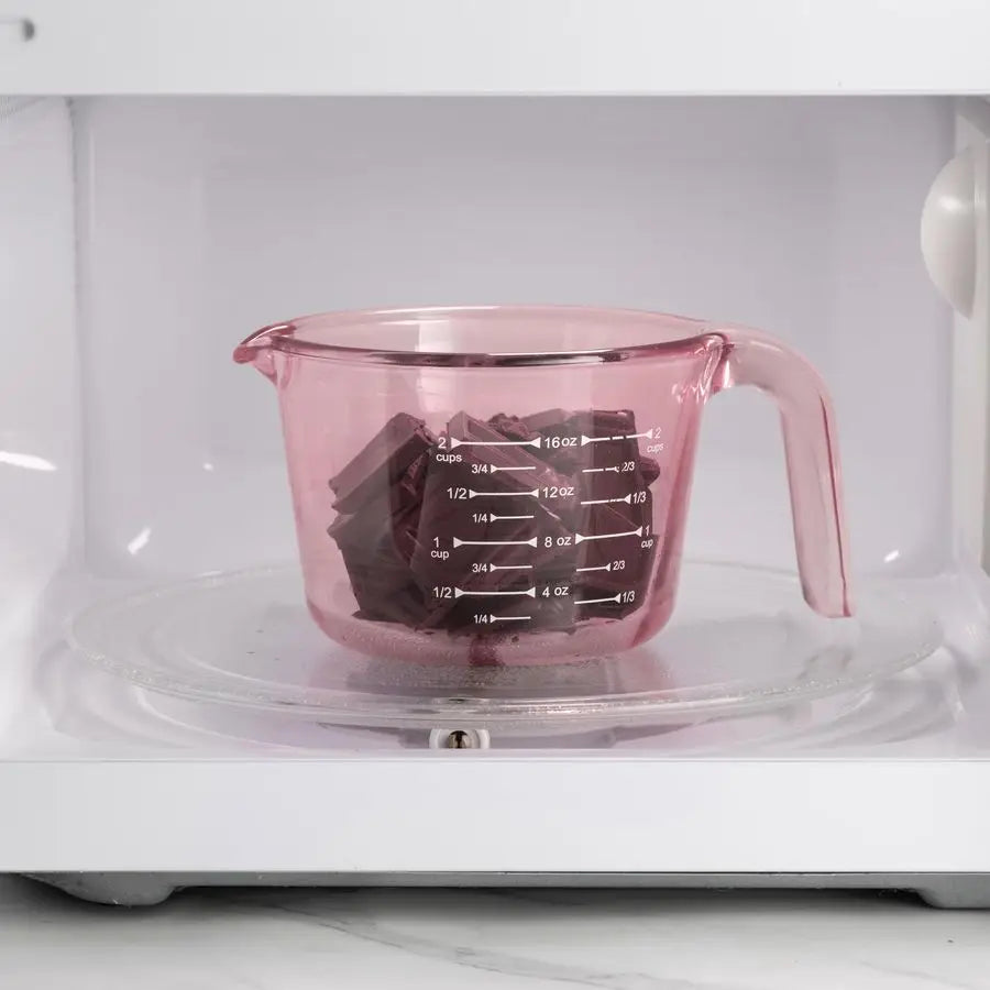 Beautifully styled pink glass measuring cups set displayed on a kitchen counter, perfect for modern kitchens.