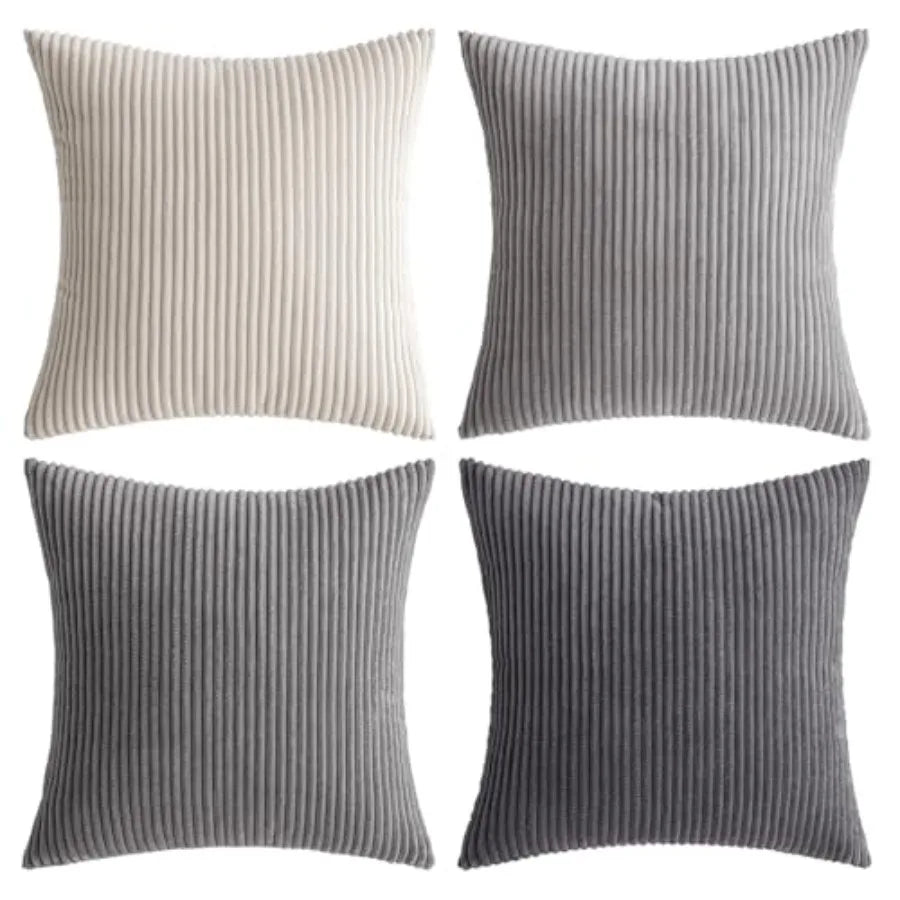 Four ribbed texture throw pillows in beige, gray, and black on a white background.