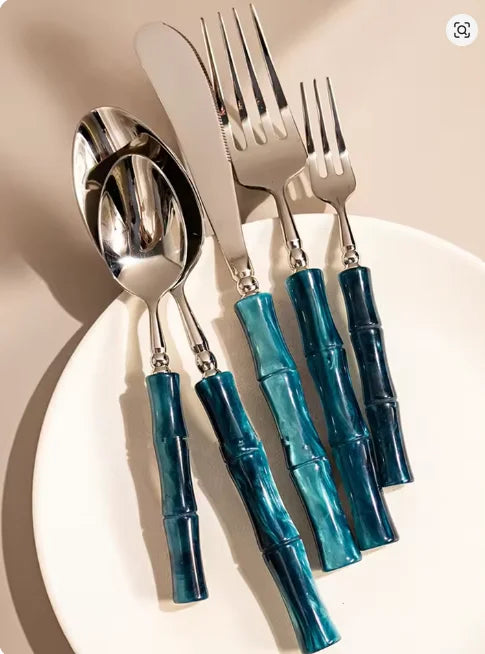 Flatware Set 18/10 Stainless Steel with Bamboo-Style Green Acrylic Handles elegantly arranged on a beautifully set dining table for a modern dining experience.