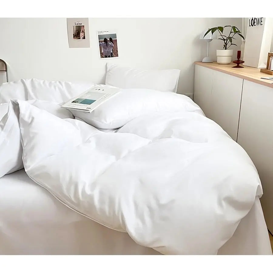 A cozy setup featuring the Luxury Hotel Collection Ultra-Soft Lightweight Queen Comforter Set, emphasizing its lightweight and breathable qualities.