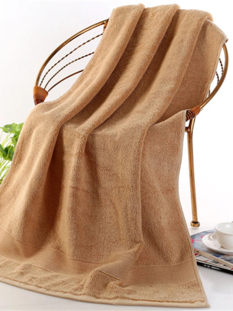 A bathroom scene featuring the Ultra-Soft High-Absorbency Terry Bath Towel hanging elegantly, showcasing its absorbency and luxurious design.