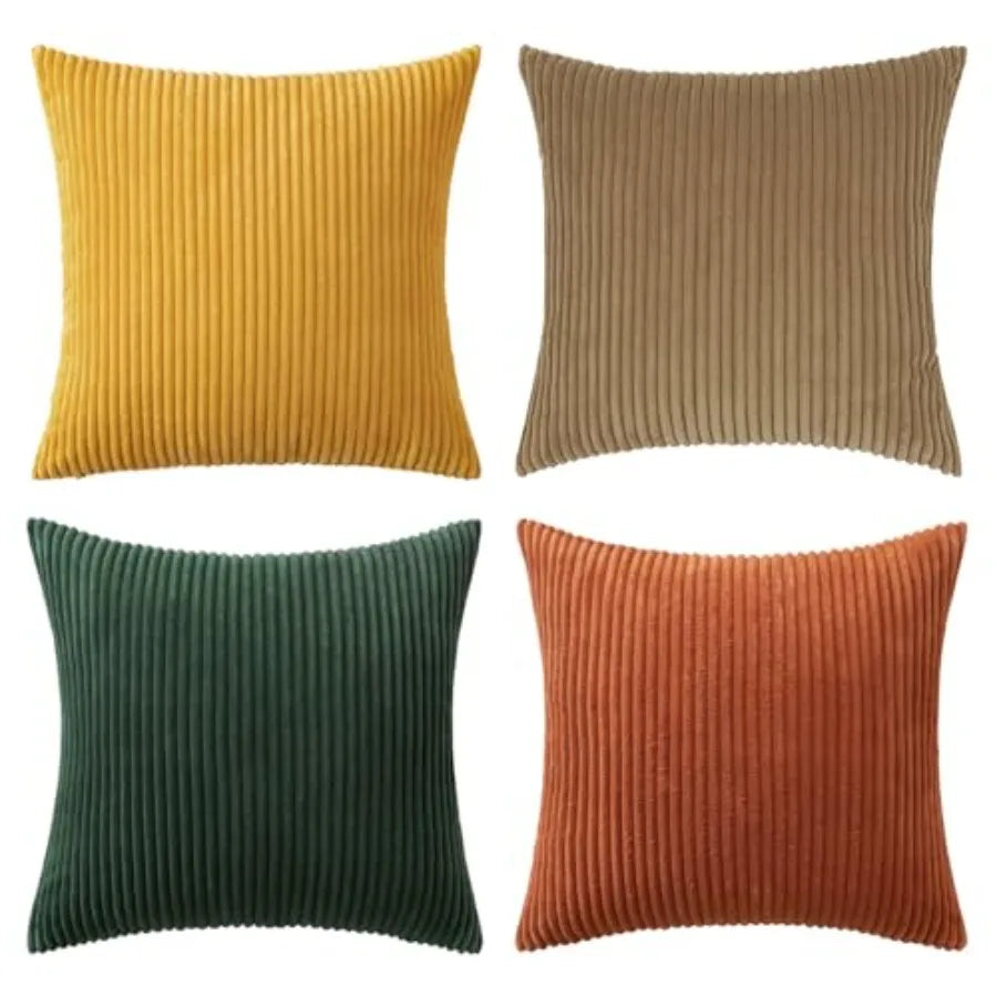 Four ribbed textured pillows in yellow, brown, green, and orange on a white background.