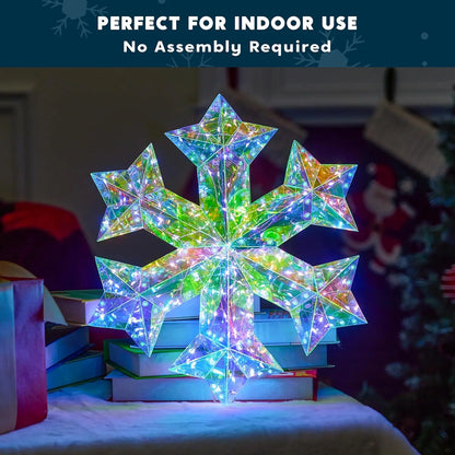 Unique 3D Iridescent Snowflake Ornament with 100 LED Cool White Lights - Perfect for indoor use, showcasing a 3D snowflake ornament sitting elegantly on a stack of books.