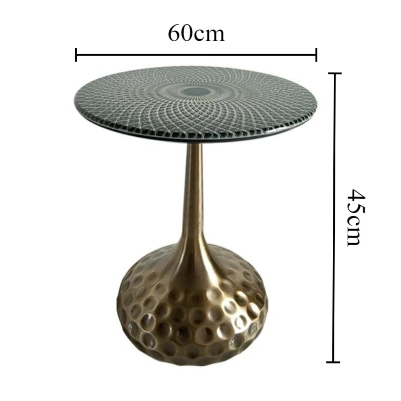 Boutique space showcasing a collection of artisan top accent tables with unique shapes and brass finishes.