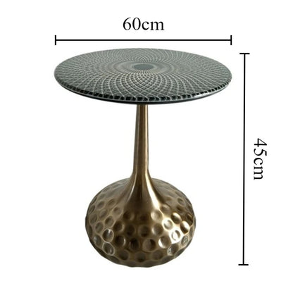 Boutique space showcasing a collection of artisan top accent tables with unique shapes and brass finishes.