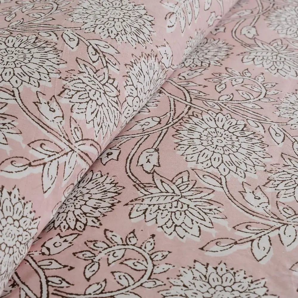 Soft and breathable cotton reversible comforter set in blush tones, perfect for a serene bedroom vibe.