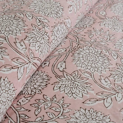 Soft and breathable cotton reversible comforter set in blush tones, perfect for a serene bedroom vibe.