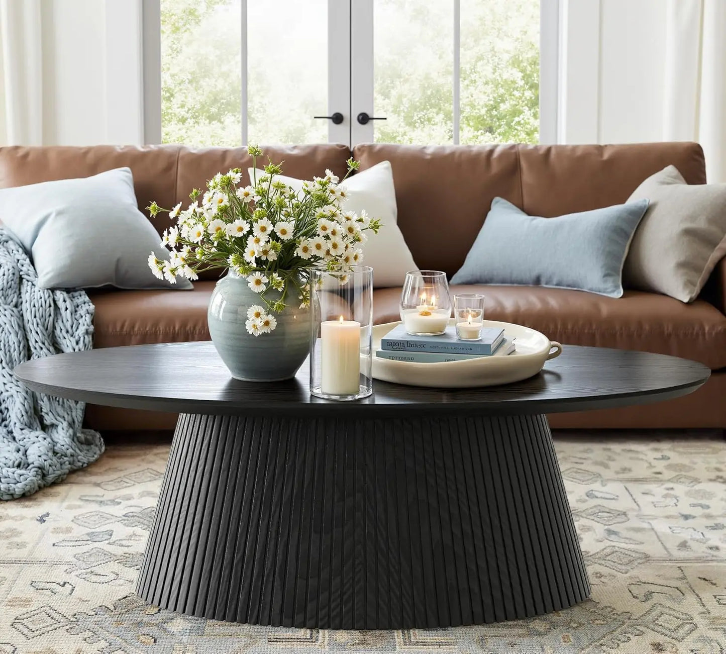 Close-up view of the black fluted pedestal base of the Mid Century Modern Coffee Table accentuating its unique design.