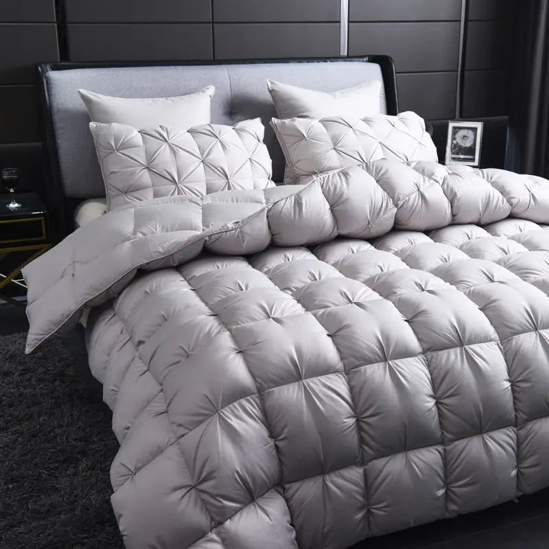 Luxurious White Goose Down Comforter showcasing its elegant pinch pleated design and soft cotton fabric.