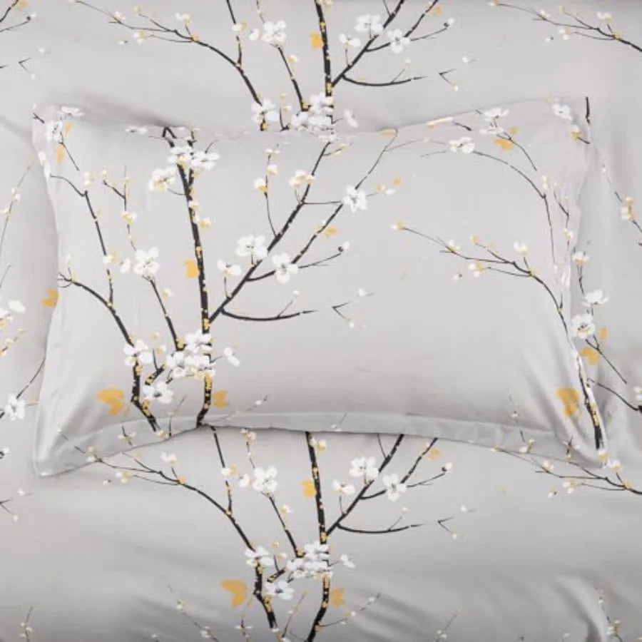 The Sage Green & Yellow Floral Duvet Cover Set Queen elegantly draped over a bed with pillows, showcasing the stylish hidden zipper feature and comfort ties.