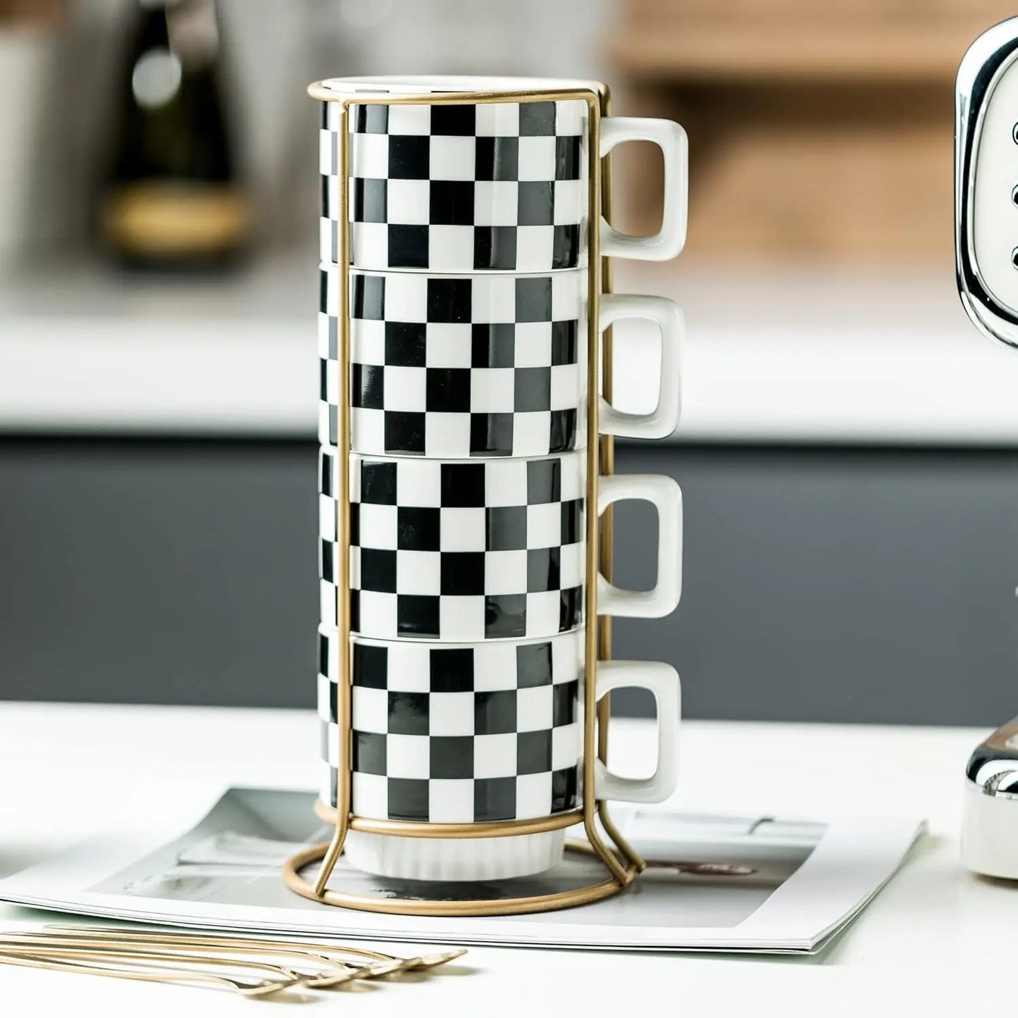 Four Modern Checkered Black And White Ceramic mugs stacked on an elegant gold-toned rack, part of the stylish checkered coffee mug set.