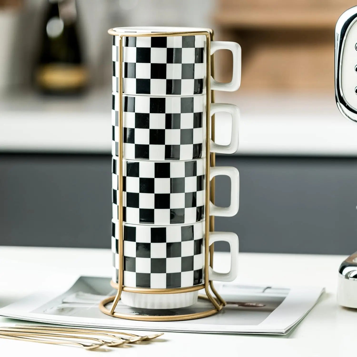 Four Modern Checkered Black And White Ceramic mugs stacked on an elegant gold-toned rack, part of the stylish checkered coffee mug set.