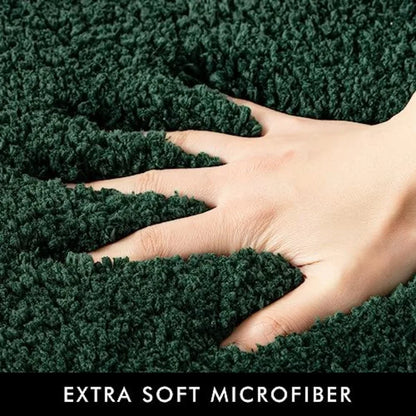 Stylish display of the 2-Piece Dark Green Microfiber Bath Rug Set complementing a modern bathroom decor.