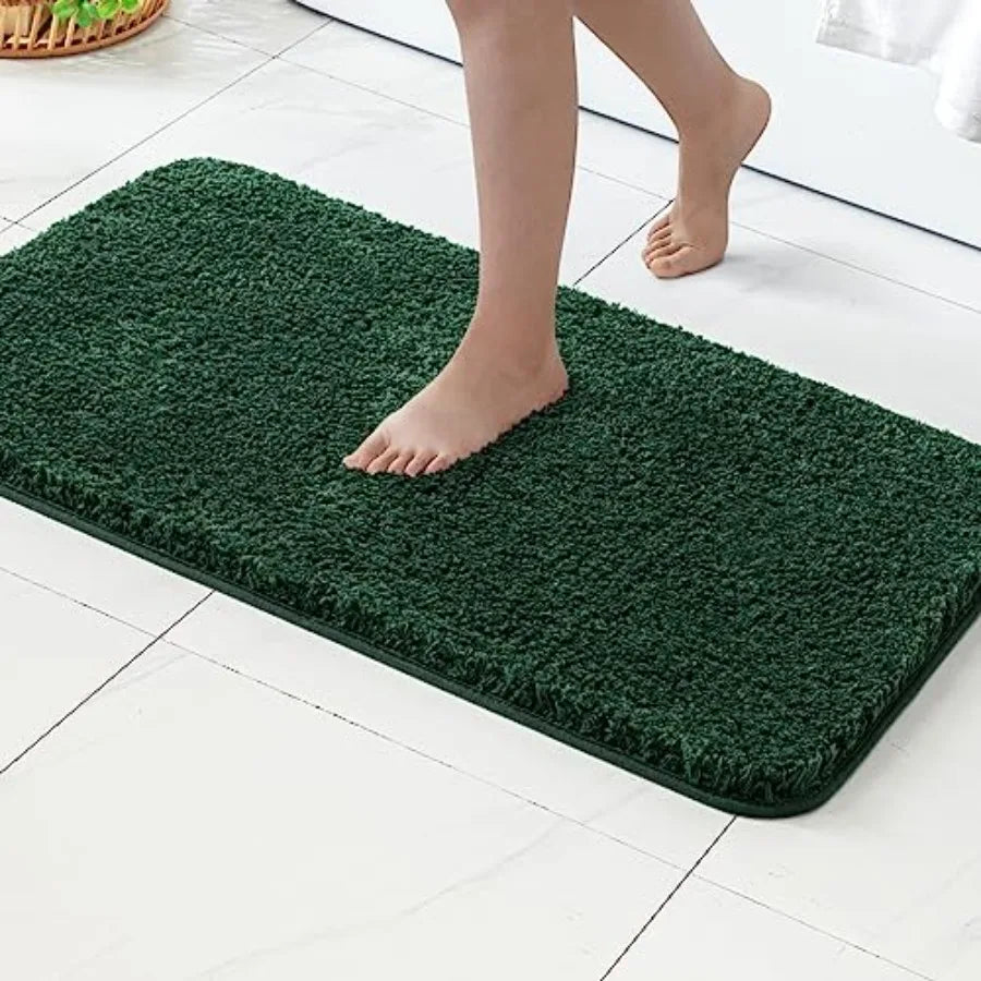 Side-by-side comparison of the 2-Piece Dark Green Microfiber Bath Rug Set showcasing different sizes.