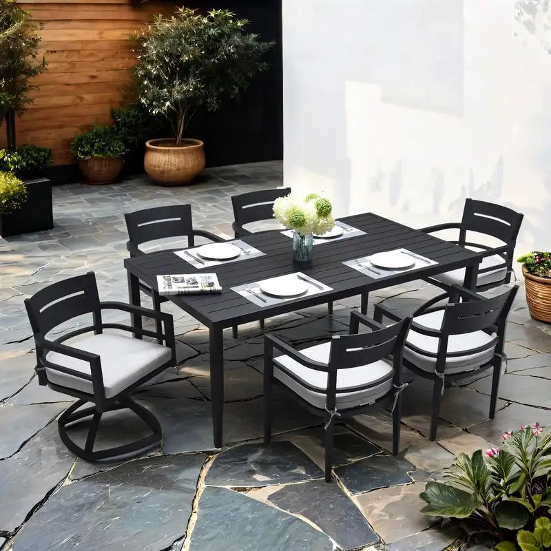 Stylish Modern Black Aluminum 7-Piece Outdoor Dining Set with Swivel Rocker Chairs & White Cushions, perfect for outdoor gatherings.