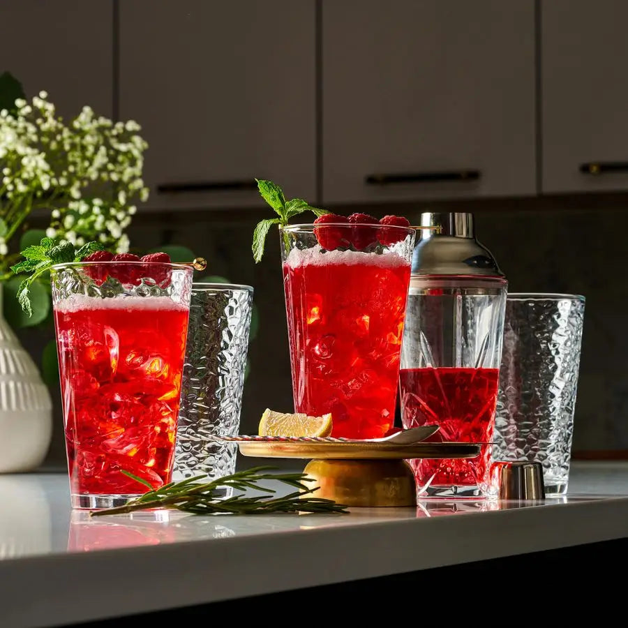 Elegant hammered glass tumblers in a set of 10, ideal for serving cocktails or water.