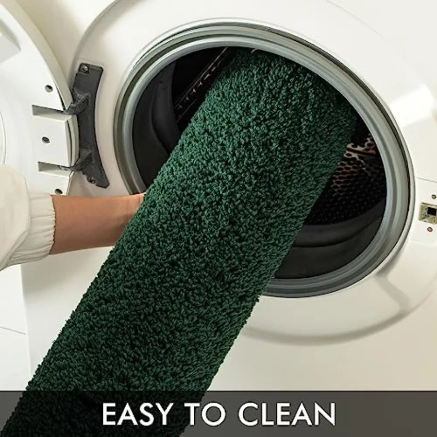 Woman stepping onto the 2-Piece Dark Green Microfiber Bath Rug Set, exemplifying comfort and style.
