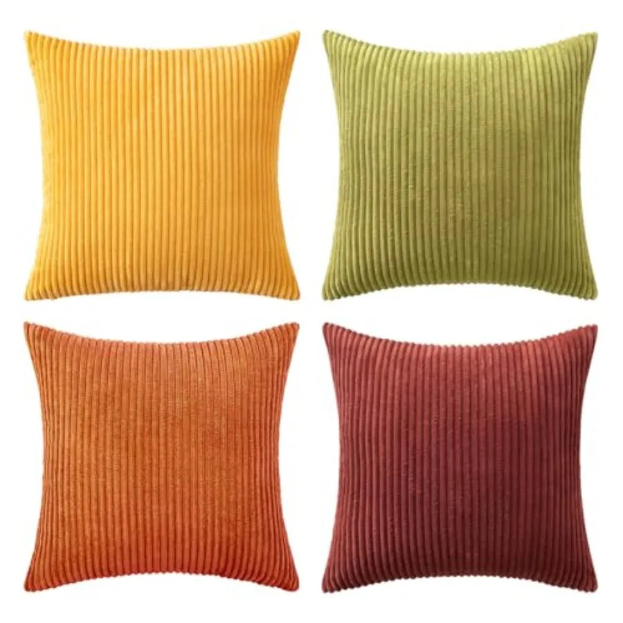 Four square ribbed throw pillows in mustard yellow, olive green, burnt orange, and dusty red, arranged in a 2x2 grid on a white background.