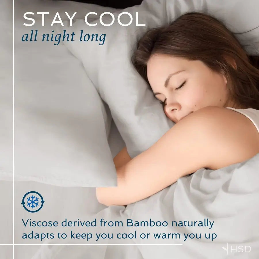 The full Luxury 4-Piece Queen Sheet Set on a queen mattress, demonstrating its perfect fit with deep pockets for comfortable sleeping.