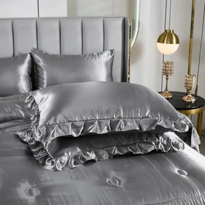 Flat lay of the Grey Satin Comforter Set including fitted and flat sheets plus 4 pillowcases, all showcasing a chic bedding ensemble.