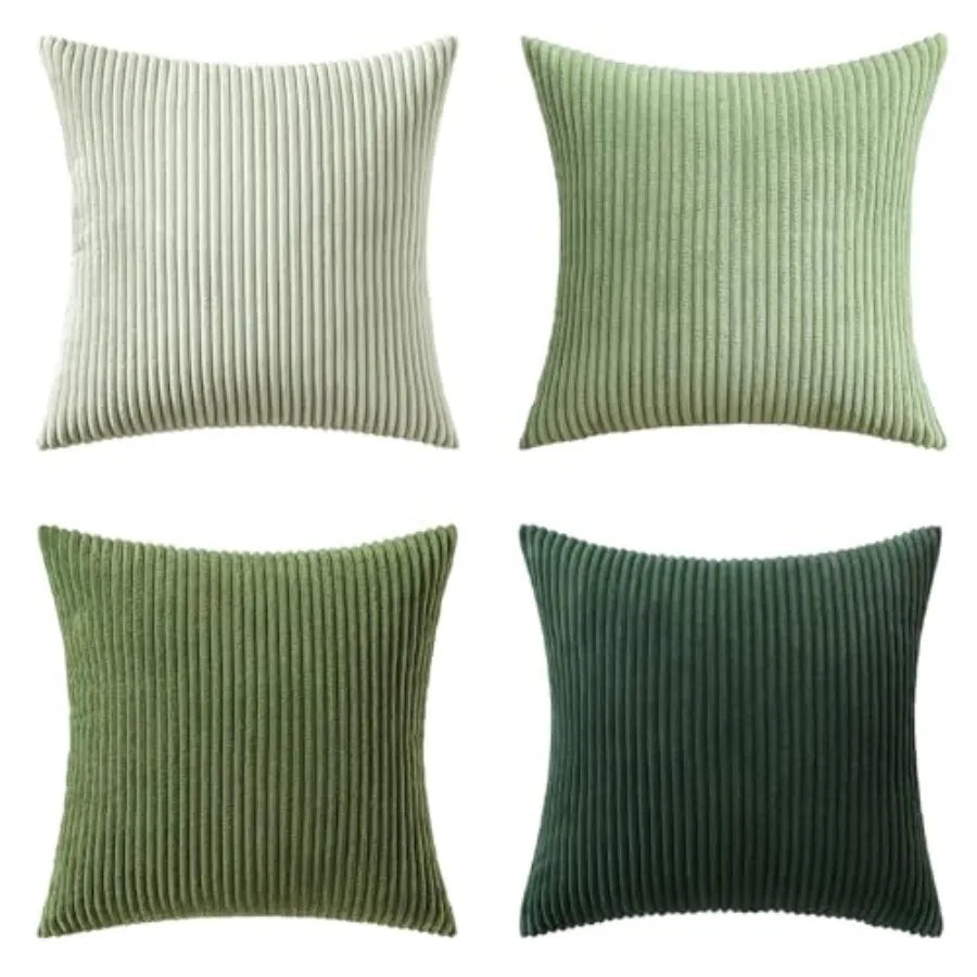 Four square ribbed throw pillows in different shades of green and light beige, arranged in a 2x2 grid on a white background.