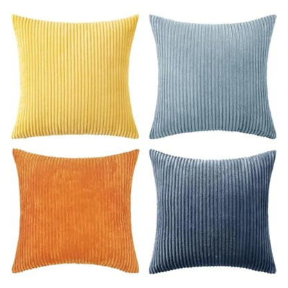 Four ribbed texture throw pillows in yellow, blue, orange, and navy on a white background.