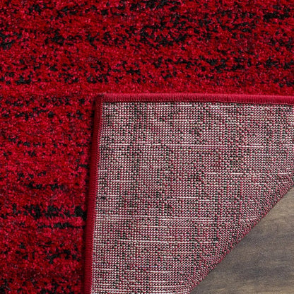 The Modern Black & Red 6' x 9' Loomed Area Rug enhancing a cozy bedroom, exemplifying a chic black and red rug for stylish decor.