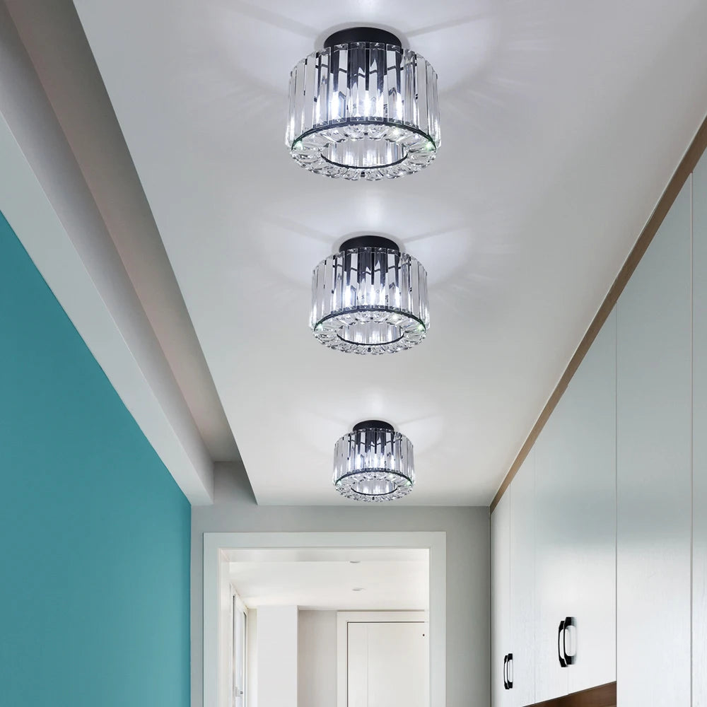 Multiple modern LED crystal pendant lights hung above a dining table, creating a contemporary lighting statement.