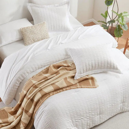 Detailing of the luxurious down alternative comforter in the 7-Piece Luxury Queen Bedding Set in Winter White.