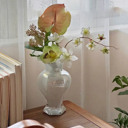 The Vintage 24Cm Opalescent Ruffled Edged Fenton Glass Vase displayed with vibrant flowers.