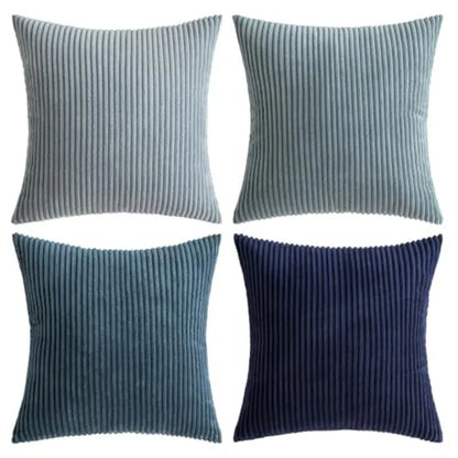 Four square ribbed throw pillows in shades of blue and navy, arranged in a 2x2 grid on a white background.
