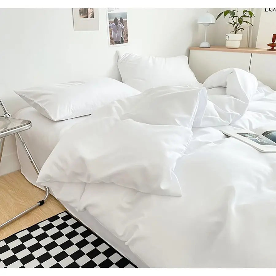 The elegant solid white design of the Luxury Hotel Collection Ultra-Soft Lightweight Queen Comforter Set, perfect for a modern luxury bedroom.