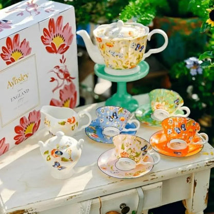 Flat lay of Aynsley Fine Bone China Tea Set with an emphasis on delicate floral patterns and vibrant colors.