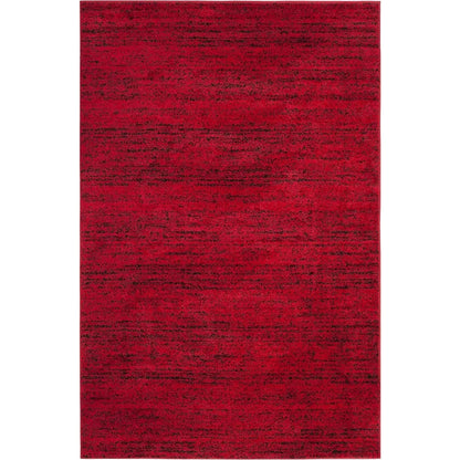 Stylish living room featuring the Modern Black & Red 6' x 9' Loomed Area Rug as a focal point, demonstrating its versatility as a black and red rug.