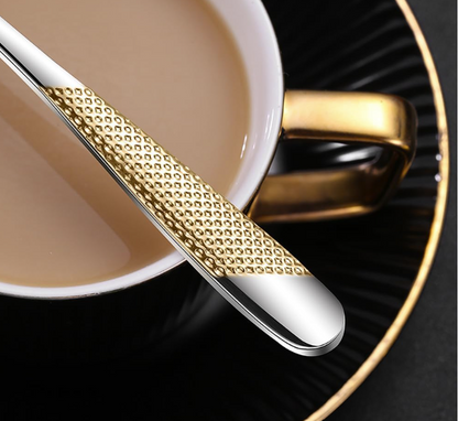 A beautiful arrangement of the Ferran stainless steel cutlery set on a rustic wooden table.