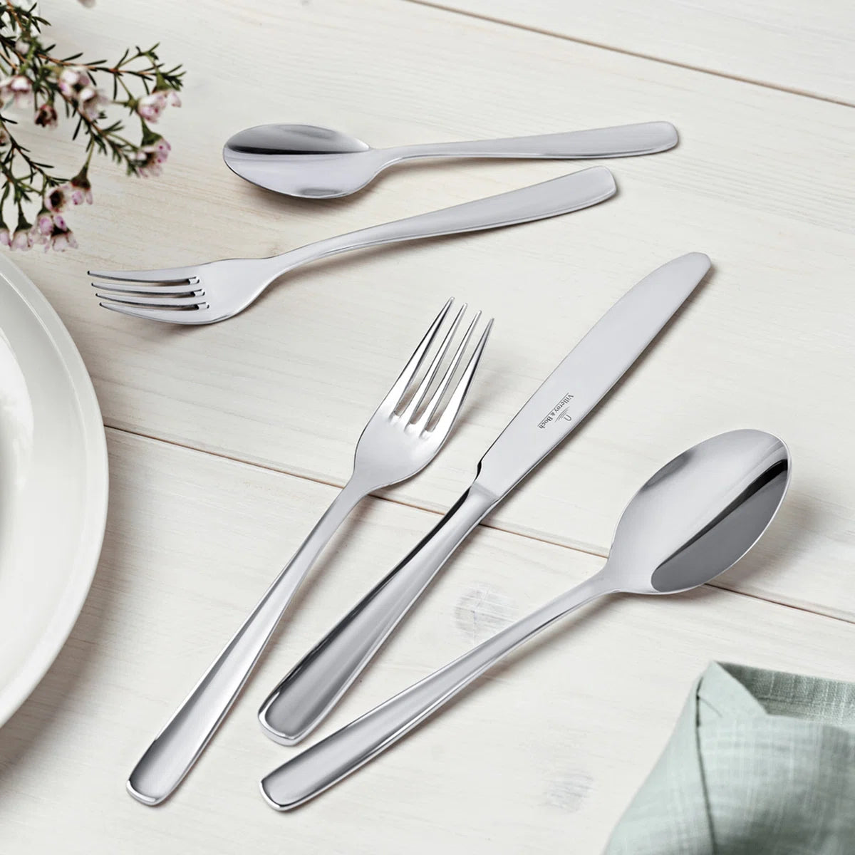 Elegant 18/10 Stainless Steel Flatware Set for 6 in a hands-on cleaning process, demonstrating its dishwasher safe quality, showcasing the efficiency of a durable stainless steel flatware set.