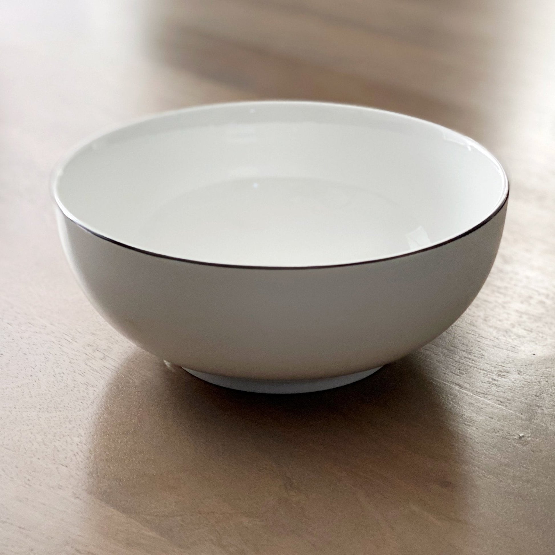 Cameron Fine Bone China Bowl 8 Inch White Base Black Rim Contemporary Serving Bowl, perfect for serving soup, pasta, salads, and snacks. Ideal fine bone china bowl for modern table settings.