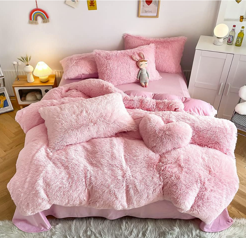 Faux Fur Duvet Cover elegantly styled with decorative pillows and throws, creating a cozy atmosphere.