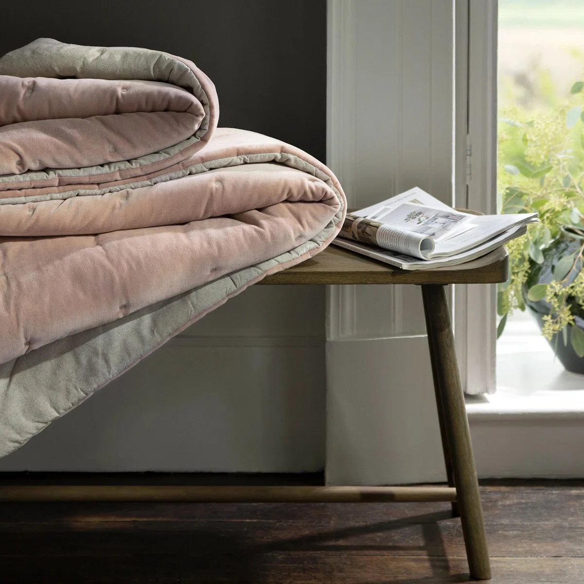 Reversible Luxury Cotton Velvet Throw folded neatly displaying its chic and elegant dusky pink quilted design, a perfect reversible cotton velvet throw.