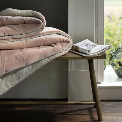Reversible Luxury Cotton Velvet Throw folded neatly displaying its chic and elegant dusky pink quilted design, a perfect reversible cotton velvet throw.