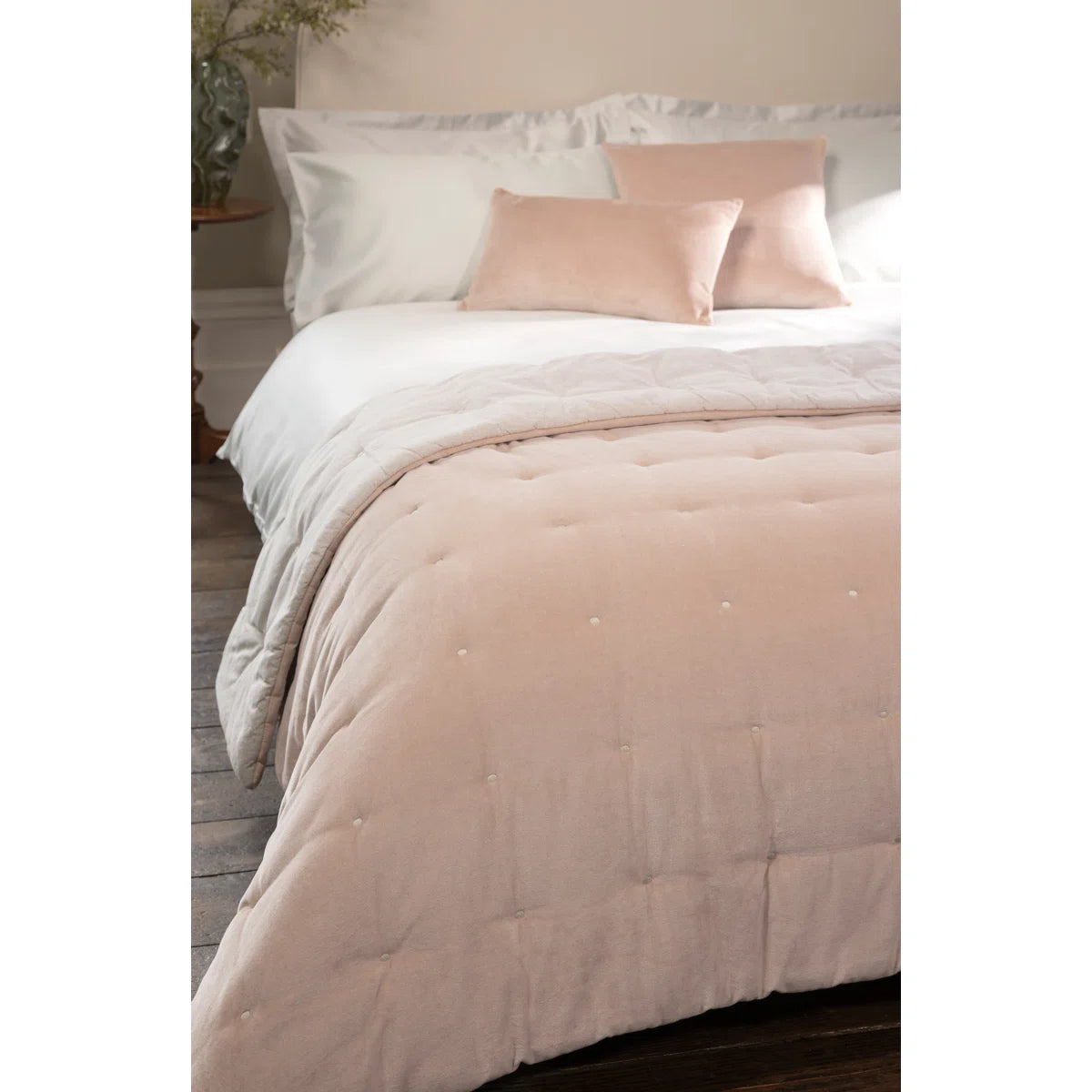 The Reversible Luxury Cotton Velvet Throw draped artistically over a stylish couch, demonstrating its functionality and aesthetic as a reversible cotton velvet throw.