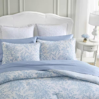 Lifestyle shot of the Bedford Blue Floral Comforter Set in a cozy bedroom setting, enhancing a vintage charm with floral designs.