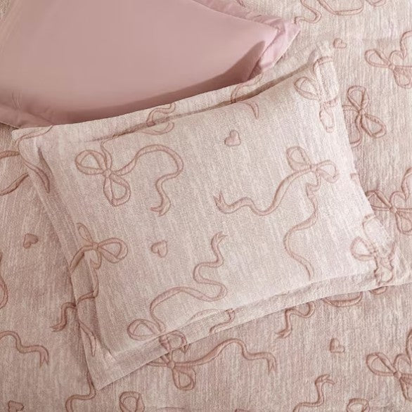 Luxury Blush Pink Bowknot Comforter Set styled with elegant accessories, an ideal blush pink comforter set for boutique-style decor.
